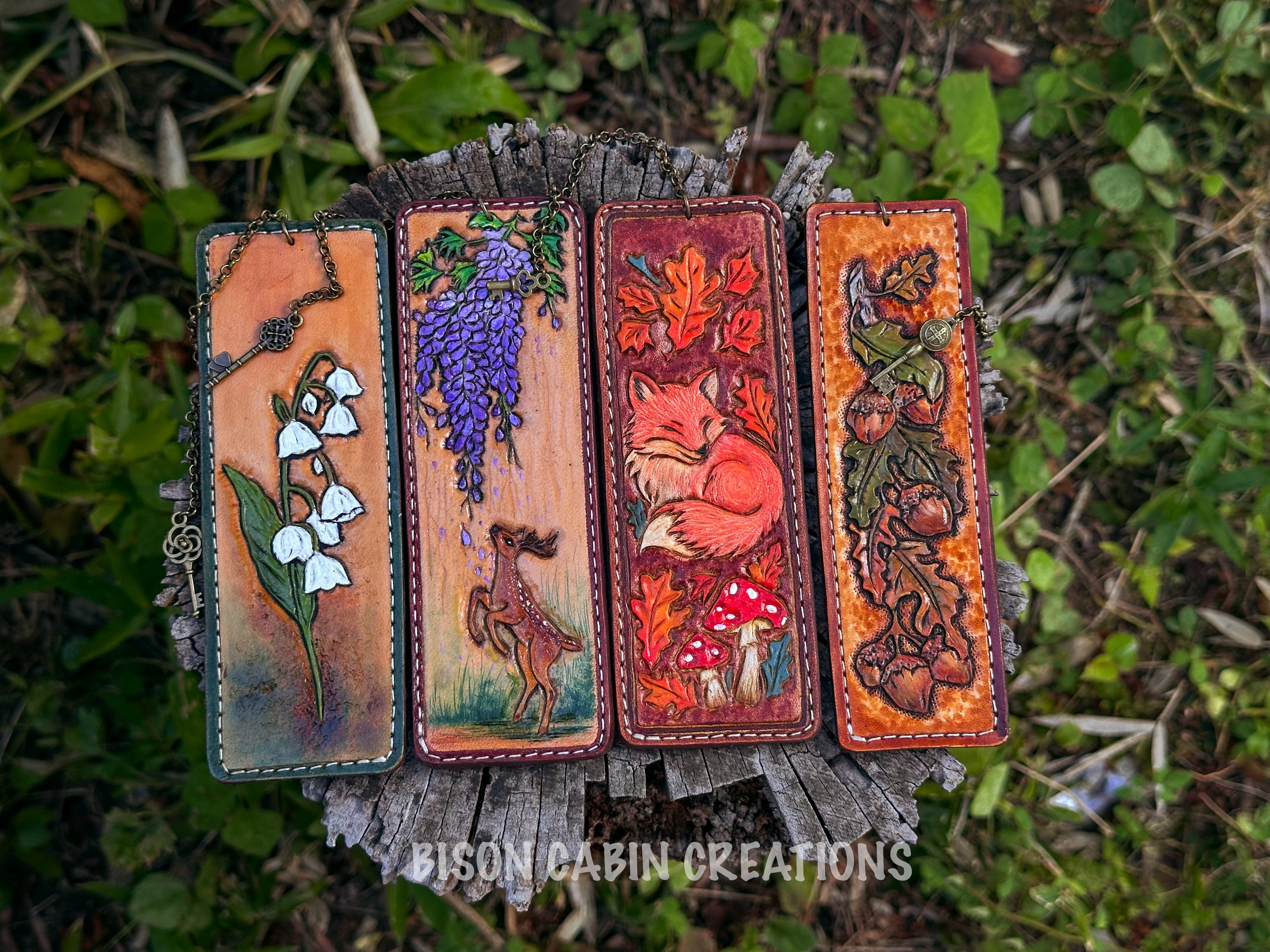 Four intricately designed leather-tooled bookmarks with a nature-inspired, woodland theme, and a forest core leather-tooled bookmark, red fox, mushroom tooled leather, handmade leather bookmark