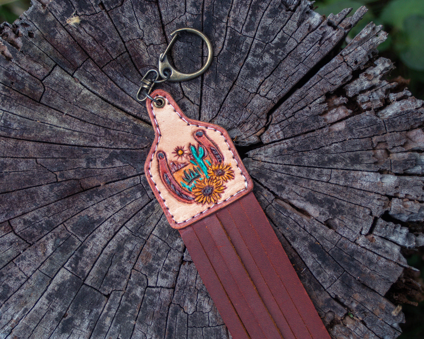 Handcrafted, tooled leather horseshoe and sunflower with a desert-designed keychain with Western rustic design and detailed leather carving for a good luck charm accessory