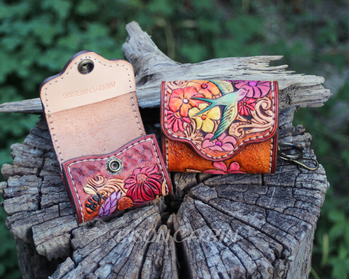 Bohemian floral AirPods case made from tooled leather with colorful flowers and bird artwork.