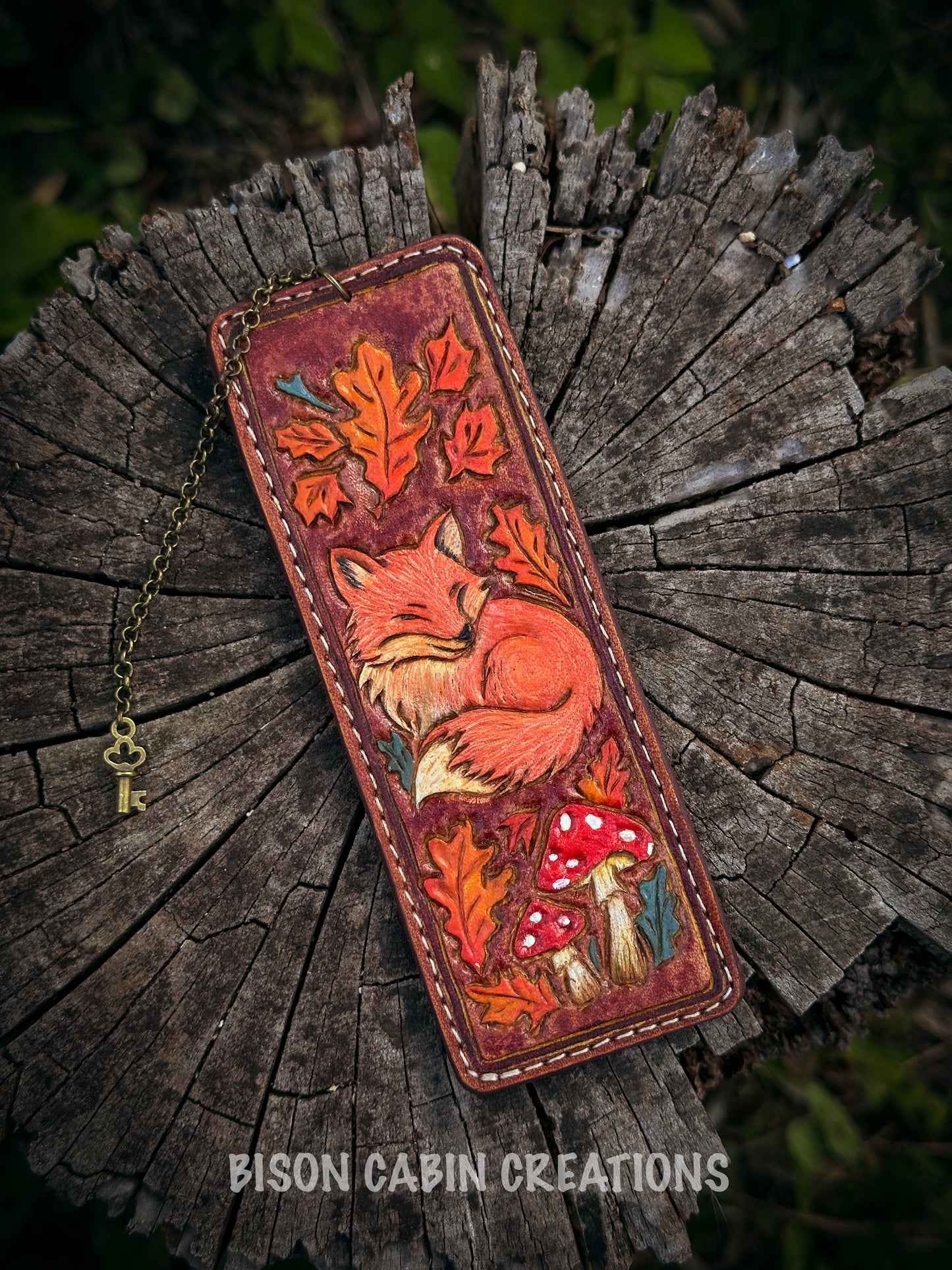 Handcrafted leather bookmark with fox and autumn design, branded 'Bison Cabin Creations.  Handcrafted Red fox tooled Leather bookmark