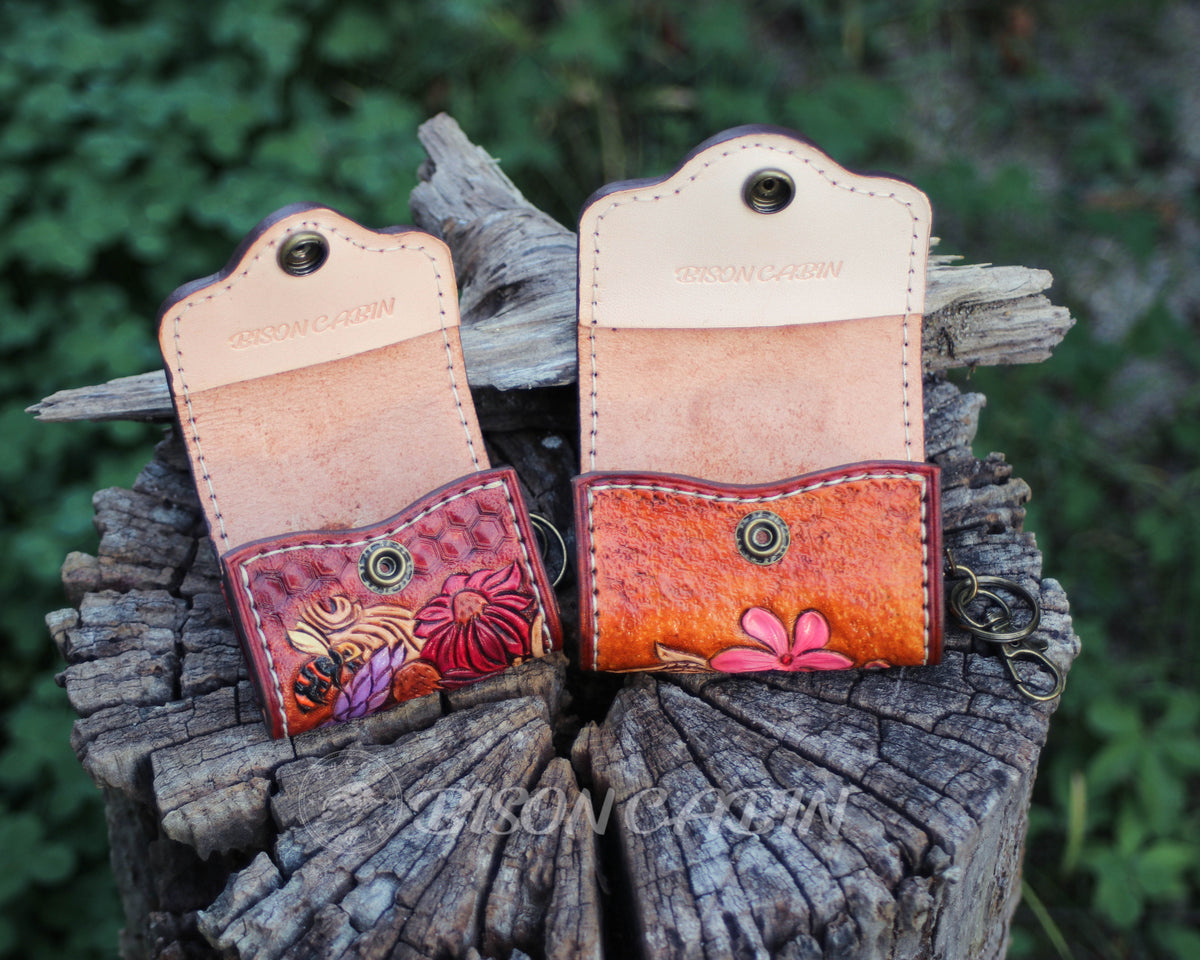 Colorful handmade AirPods case with button opened ,featuring raised leather flowers and a delicatewestern  motif.