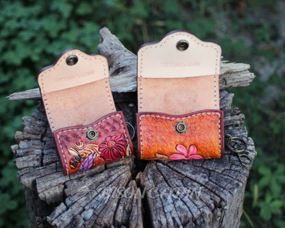 Colorful handmade AirPods case with button opened ,featuring raised leather flowers and a delicatewestern  motif.
