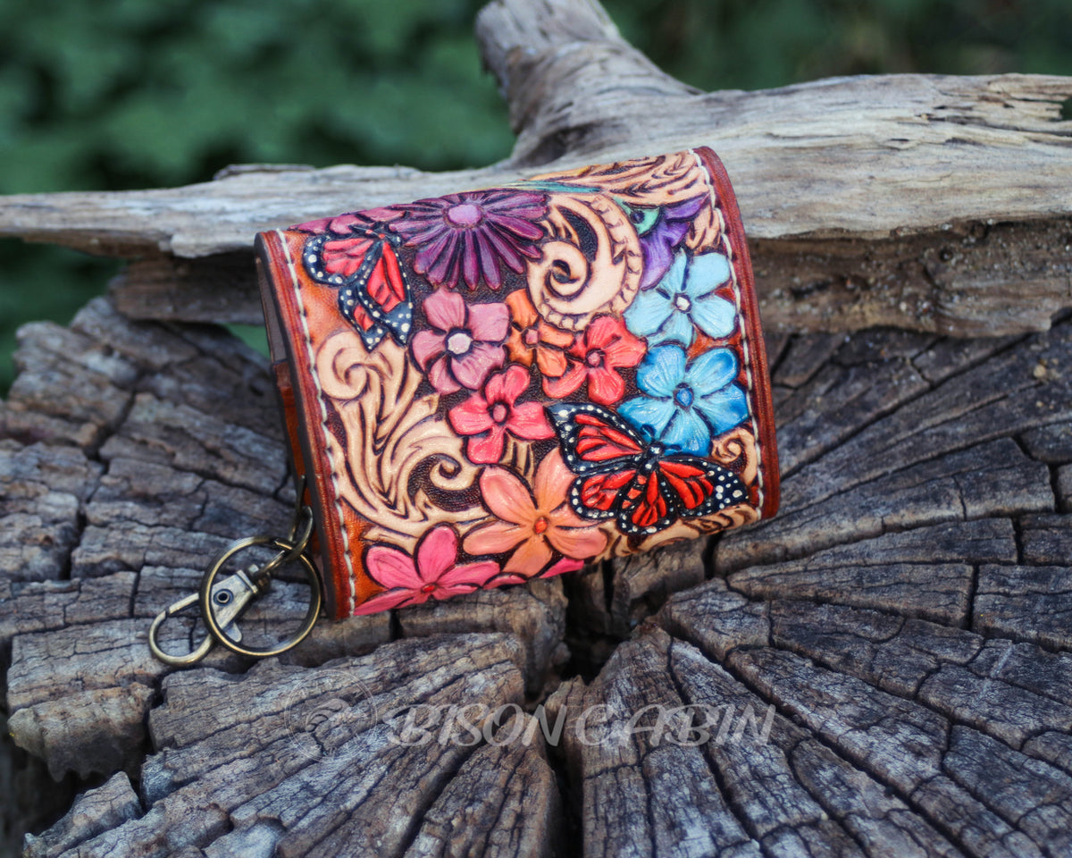 Handcrafted wildflower leather AirPods cases featuring embossed flowers, western scrolling with monarch butterfly  and antique-style metal hardware.