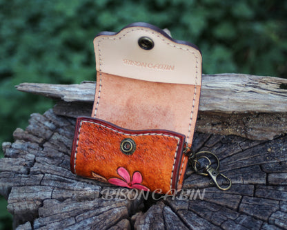 Handcrafted tooled  leather AirPods cases featuring embossed flowers, and antique-style metal hardware.