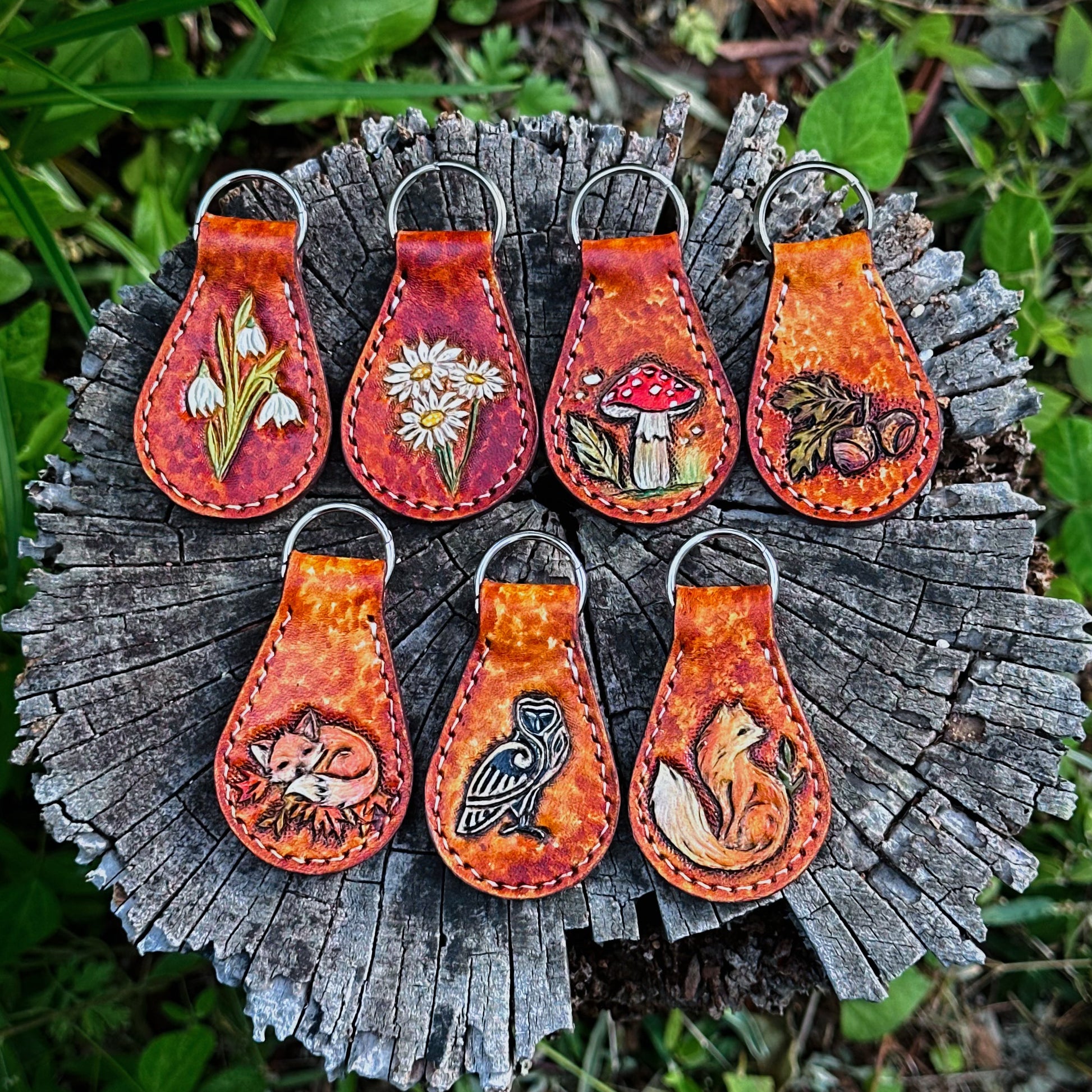  leather tooled keychains with a nature-inspired key chain ring. Woodland and forest core tooled leather key fob 