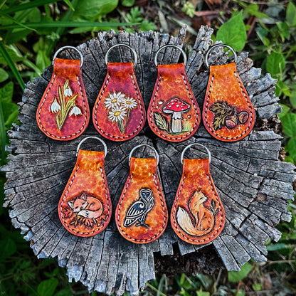  leather tooled keychains with a nature-inspired key chain ring. Woodland and forest core tooled leather key fob 