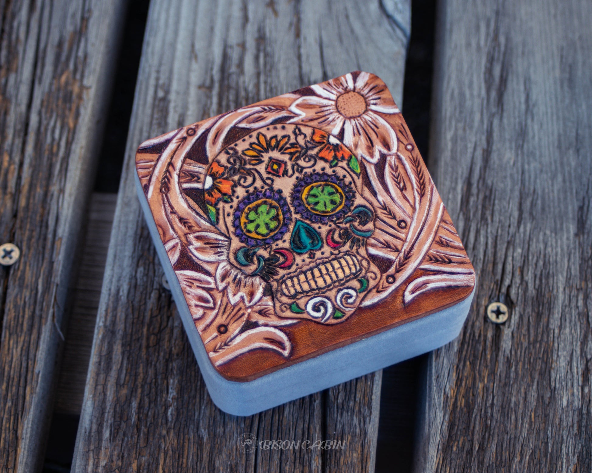 Hand tooled leather travel jewelry box featuring gothic skull design, rustic handcrafted storage case for rings, earrings, and small jewelry accessories