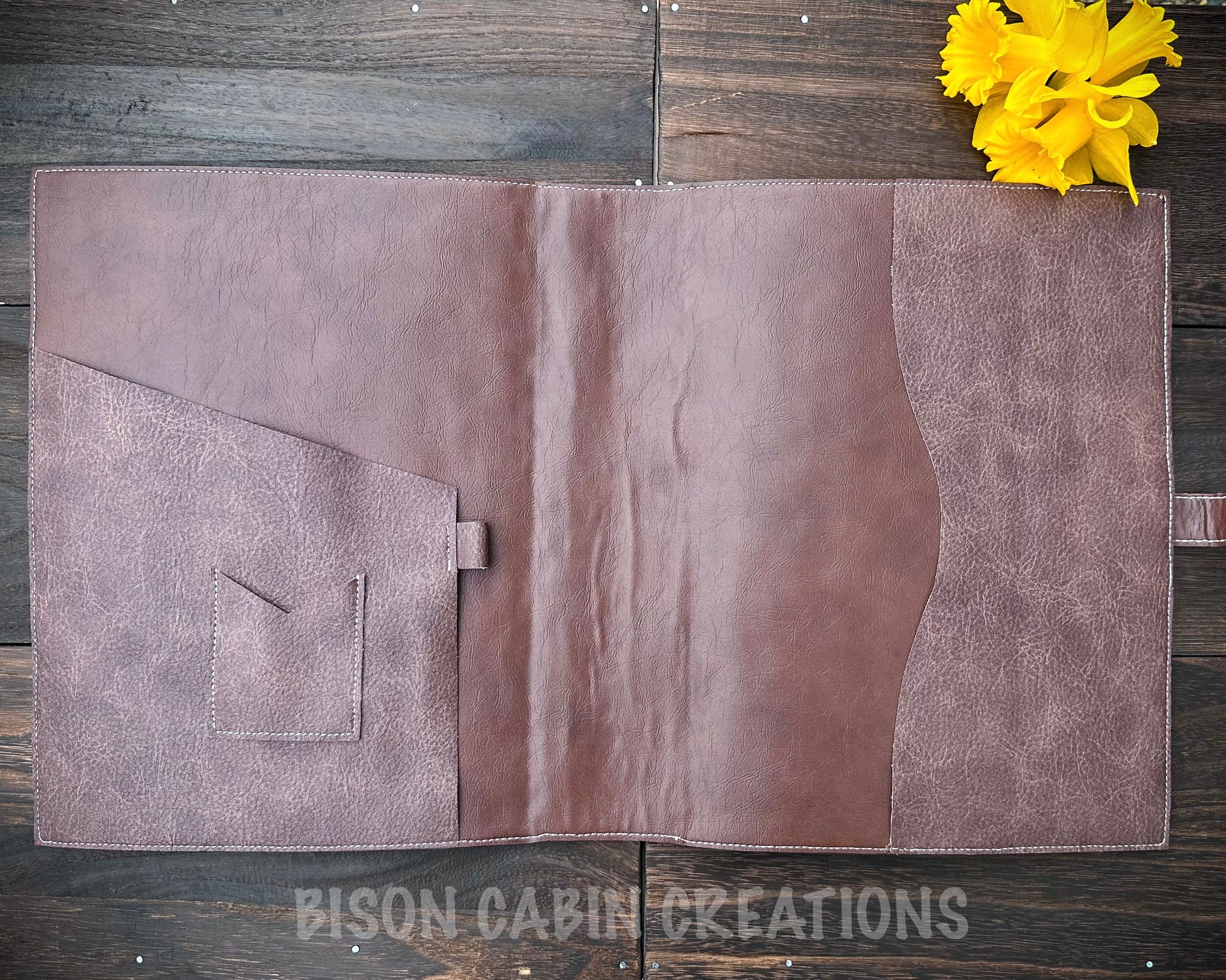 Handcrafted leather notebook cover interior with stitched pockets and durable brown leather construction