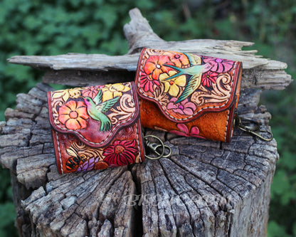 Handcrafted tooled leather AirPods case featuring colorful flowers and a hummingbird and Songbirds design.