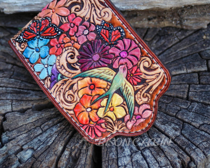 Hand tooled leather AirPods holder inspired  with vibrant blossoms, swirling patterns, and sparrow bird details.