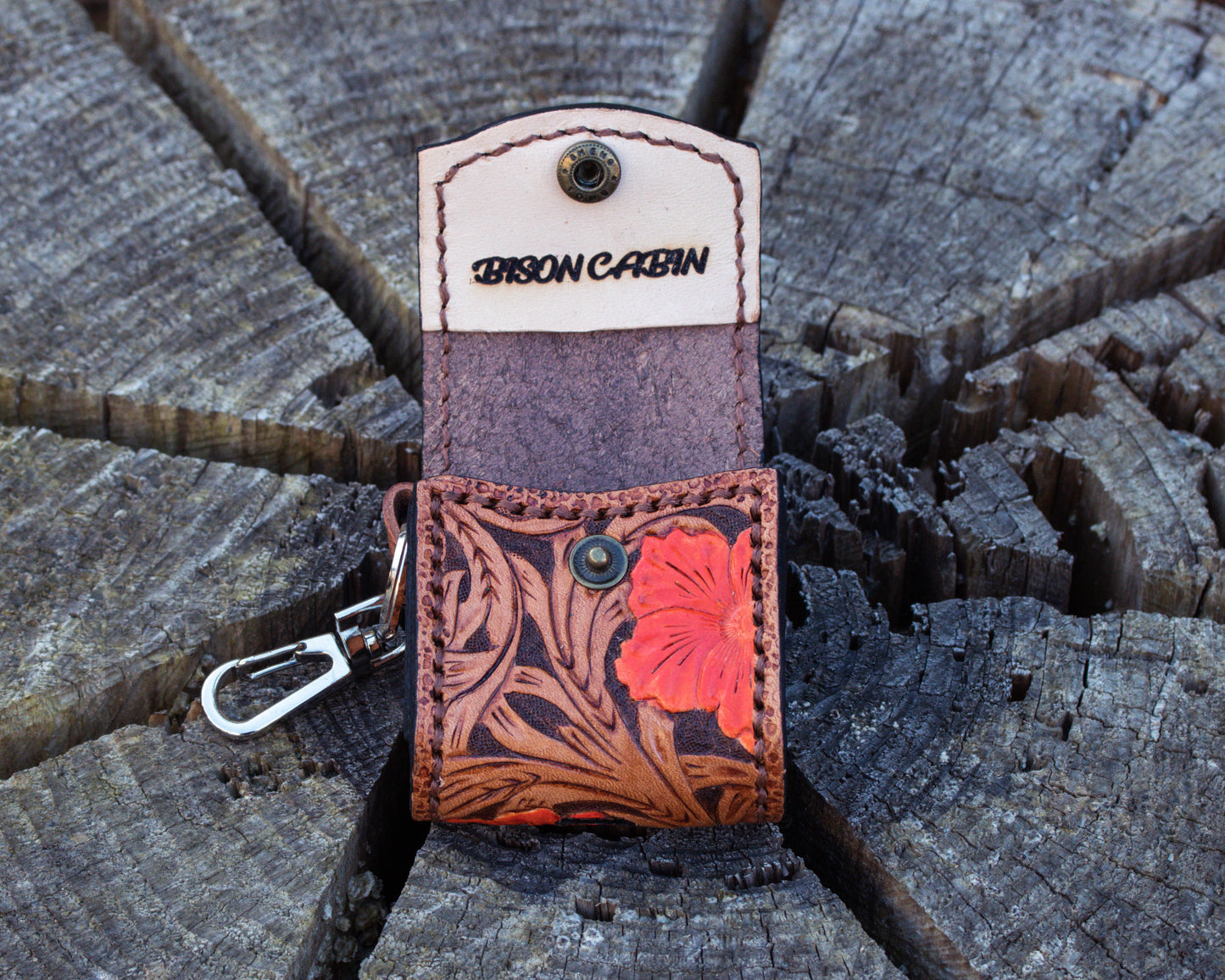 Interior view of rustic leather AirPods case featuring floral hand tooled design and snug protective storage for AirPods