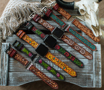 Collection of handcrafted tooled leather Apple Watch bands featuring boho sunflower, turquoise Celtic, oak leaf, red rose, tulip, and western floral designs