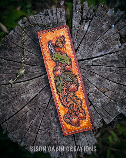 Handcrafted leather bookmark with nature-themed design featuring an Oak leaf, 'Bison Cabin Creations' branding.