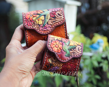 Rustic brown leather AirPods case with embossed wildflowers and vibrant hummingbirds and sparrow carved cases