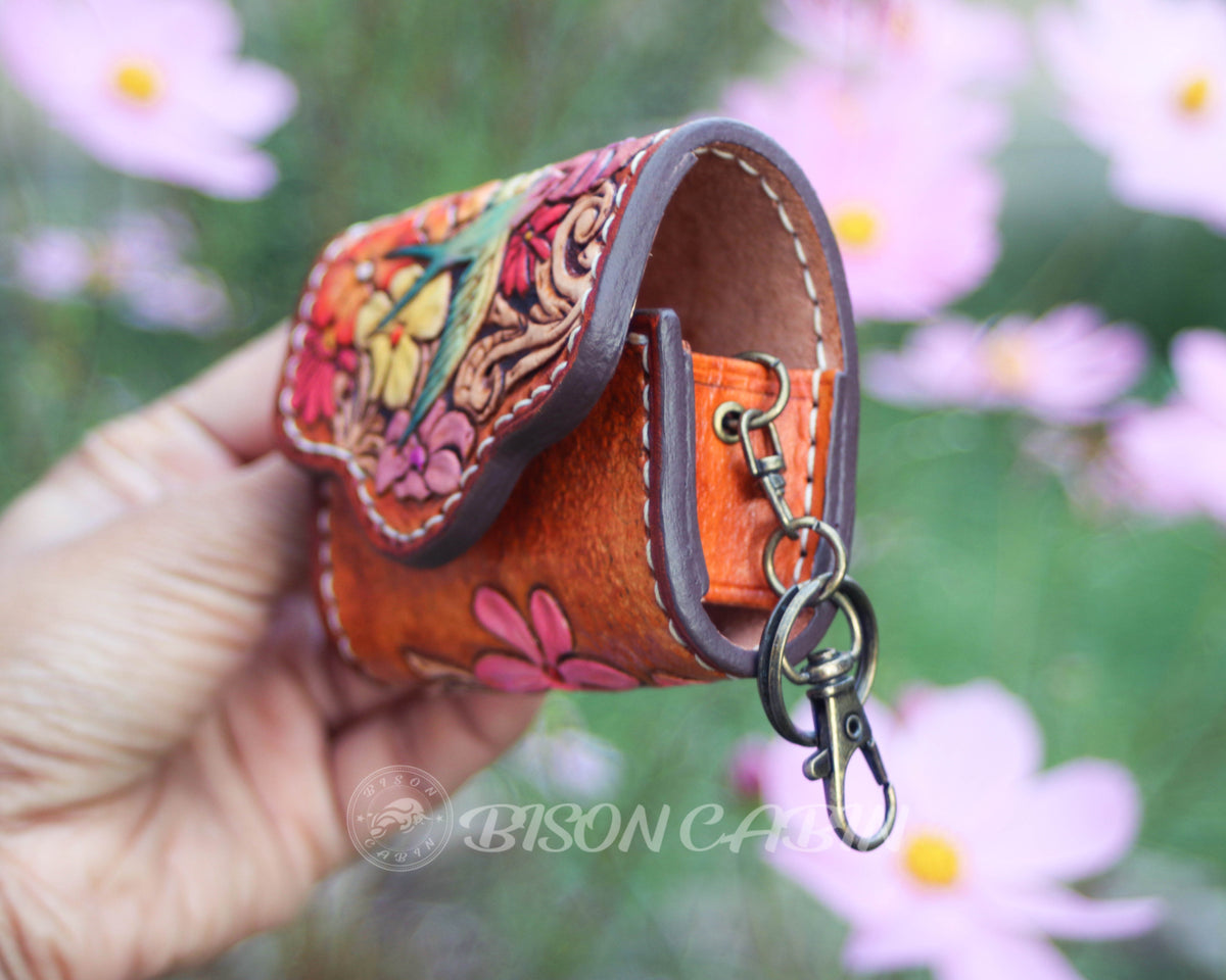 Close-up of a handcrafted leather AirPods case showcasing key chaing 