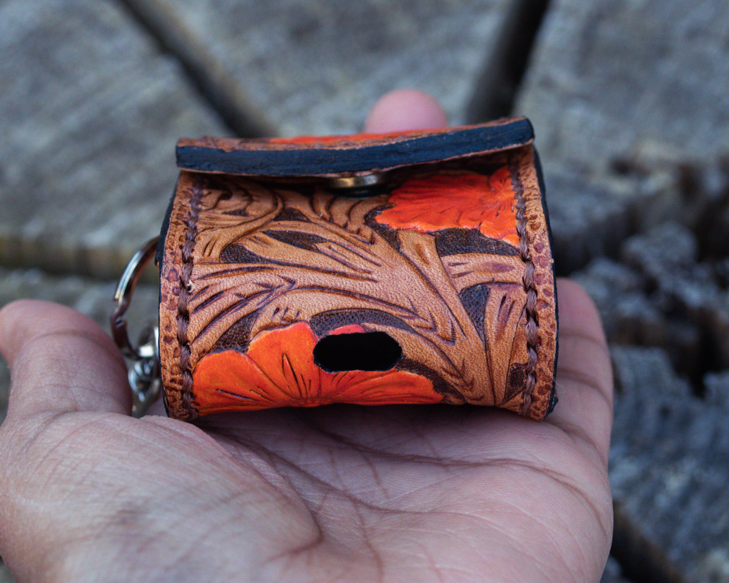 Tooled leather AirPods case with floral Western pattern, closed compact design offering durable handmade protection for AirPods

