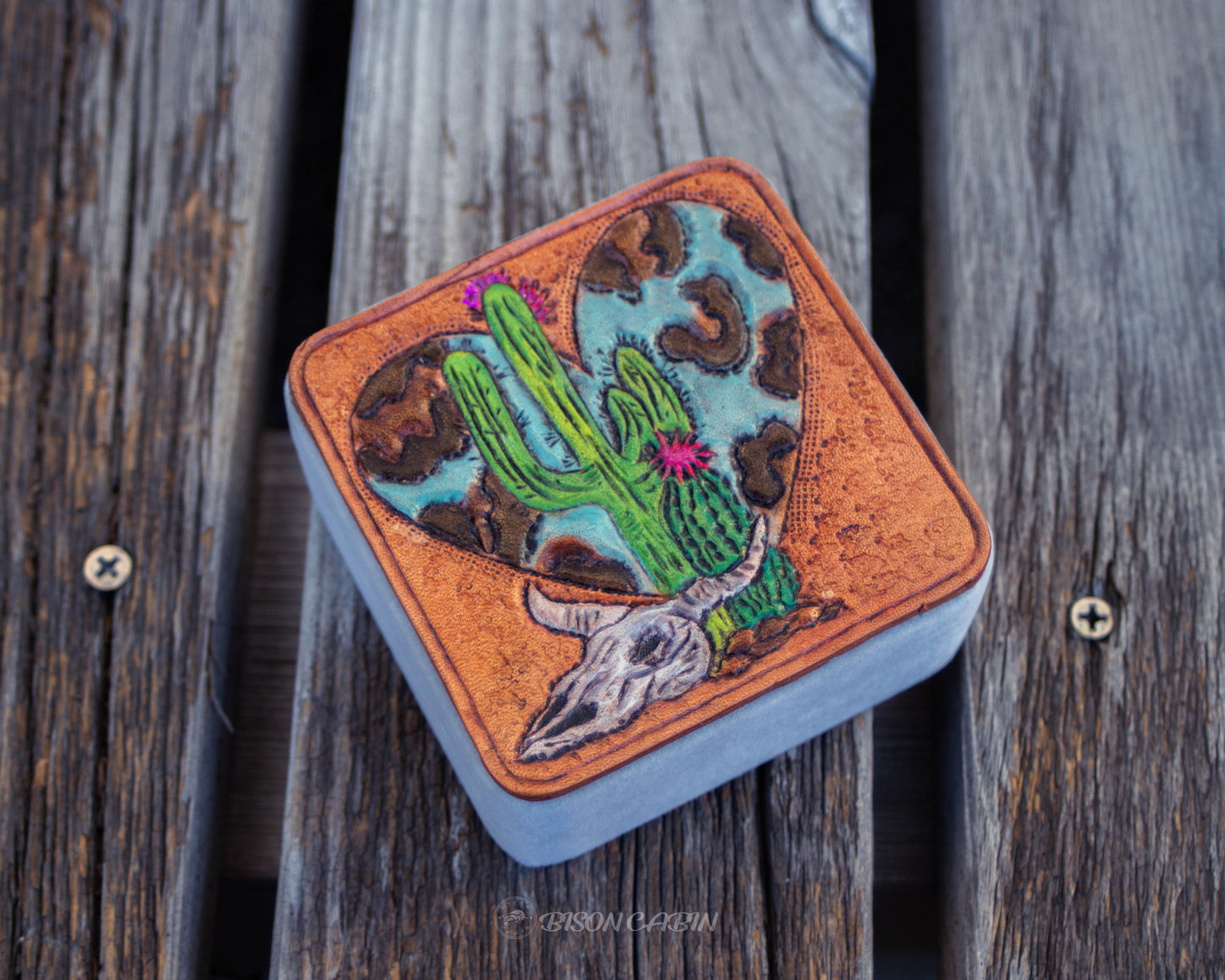 Hand tooled leather travel jewelry box with cactus and Western desert design, rustic handmade storage case for rings, earrings, and small accessories