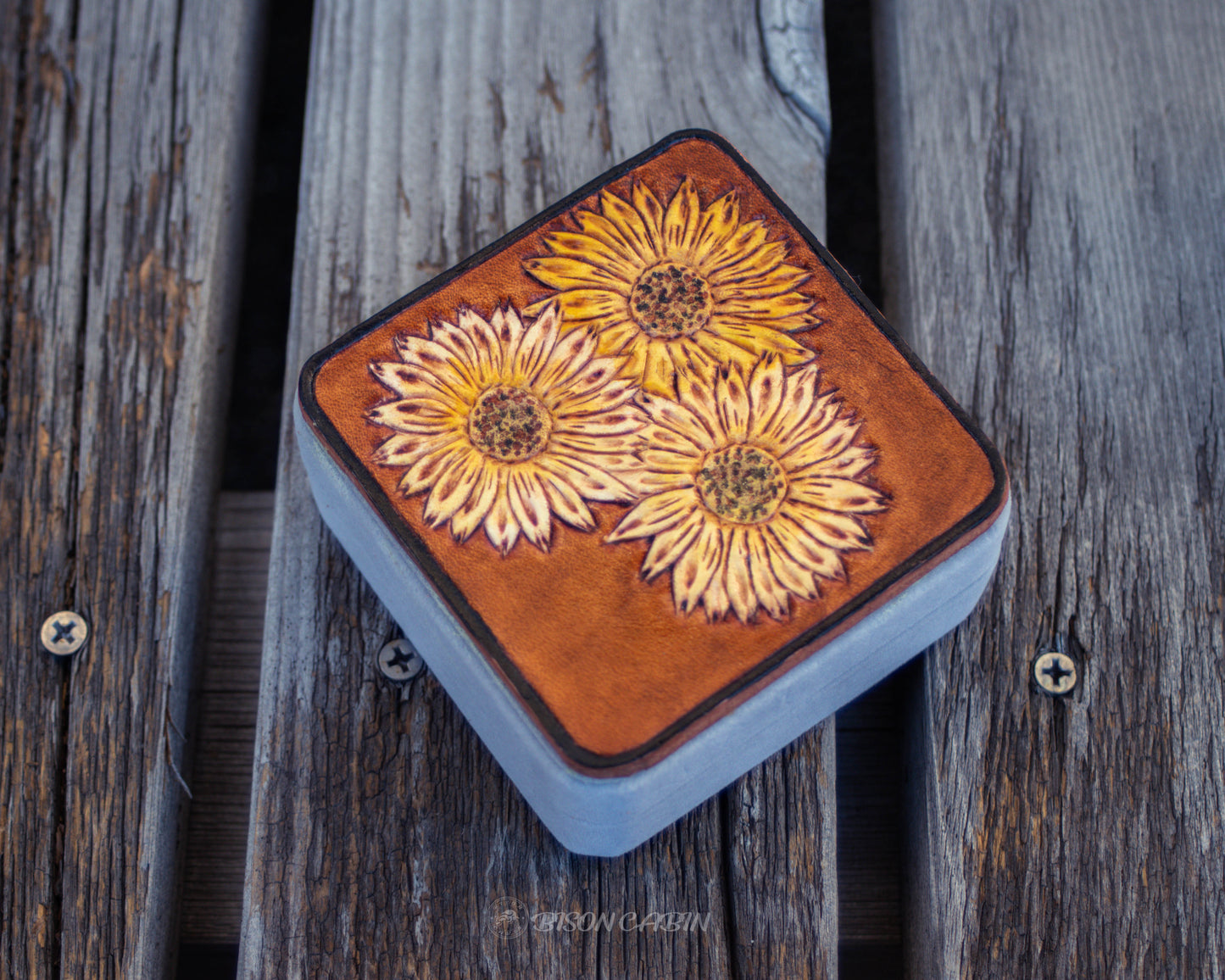 Hand tooled leather jewelry box featuring sunflower floral design, rustic handcrafted travel case for storing rings, earrings, and small accessories
