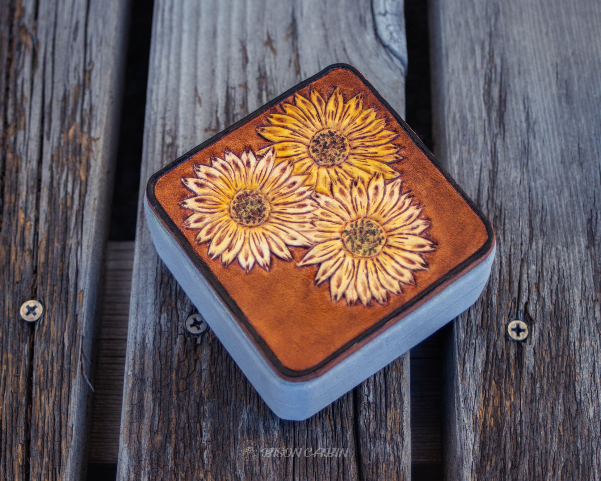 Hand tooled leather jewelry box featuring sunflower floral design, rustic handcrafted travel case for storing rings, earrings, and small accessories