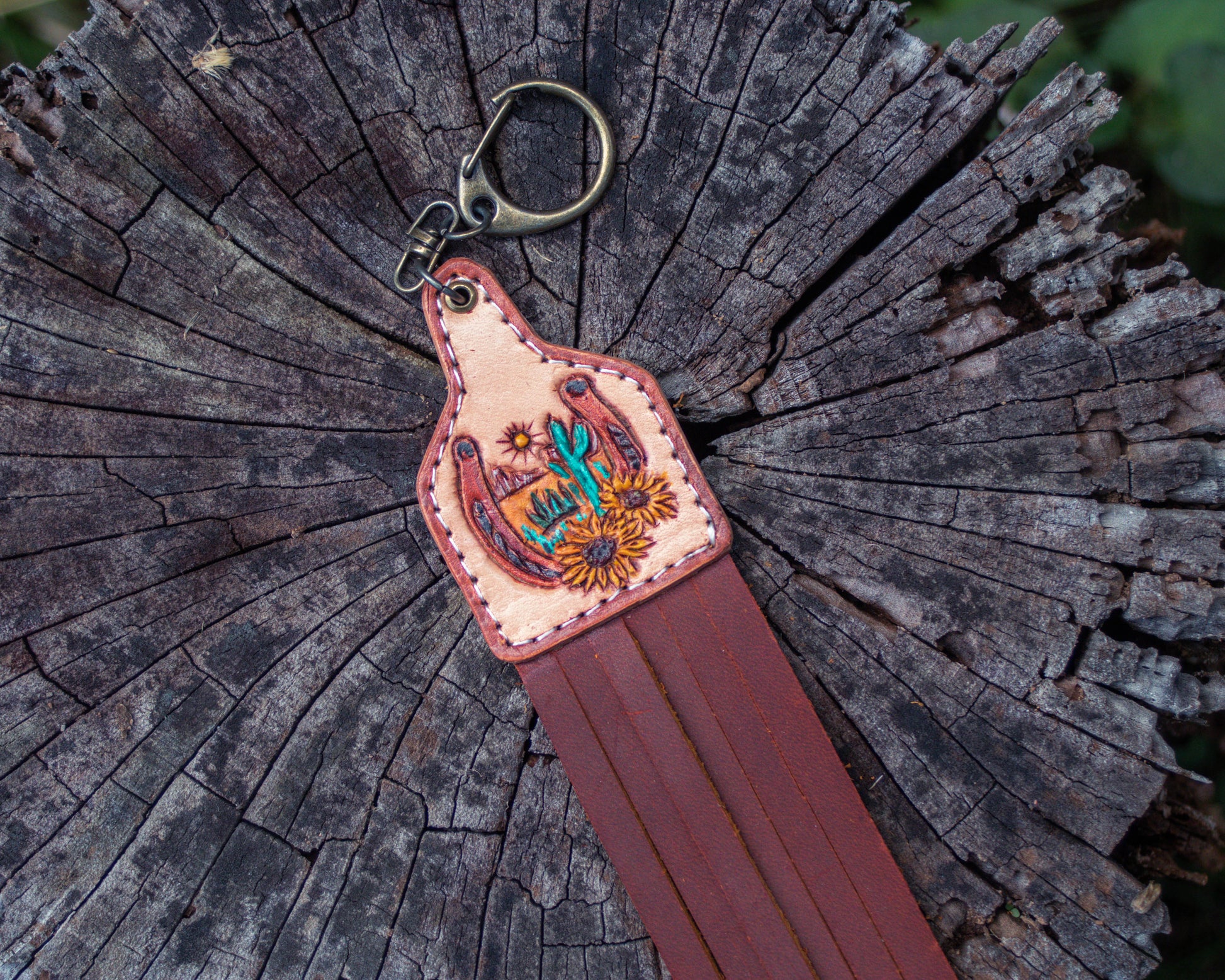 Handcrafted, tooled leather horseshoe and sunflower with a desert-designed keychain with Western rustic design and detailed leather carving for a good luck charm accessory