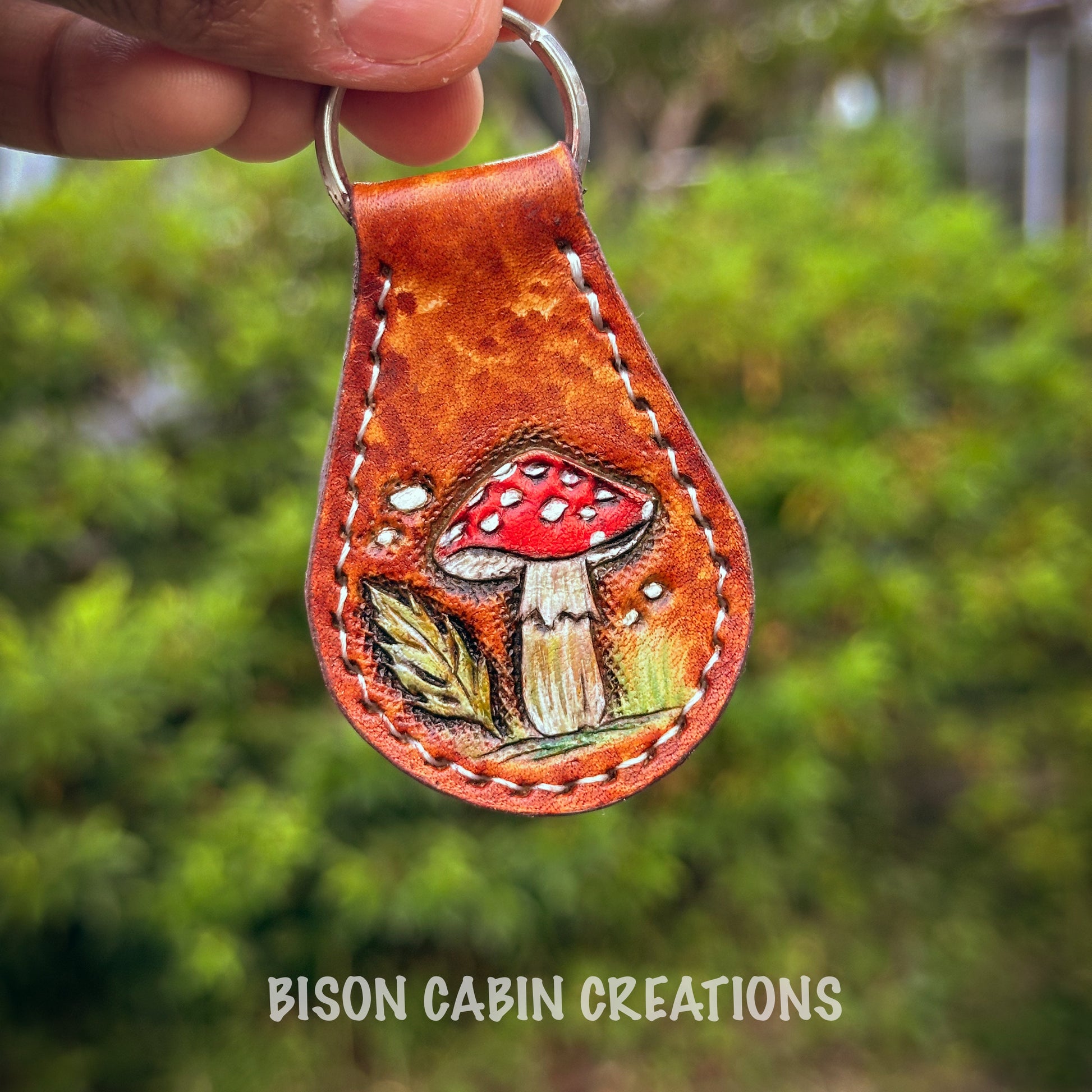 Hand-made, tooled leather keychain featuring Mushroom, rustic hand-painted details with medium brown leather, and nature-inspired key fob.
